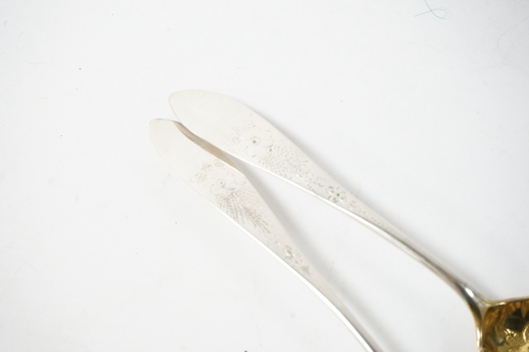 A pair of late 18th/early 19th century German parcel gilt white metal Celtic tip berry spoons, with engraved foliate decoration, maker's mark WHG? in italic, stamped with rampant lion below 13 probably Heidelberg city ma